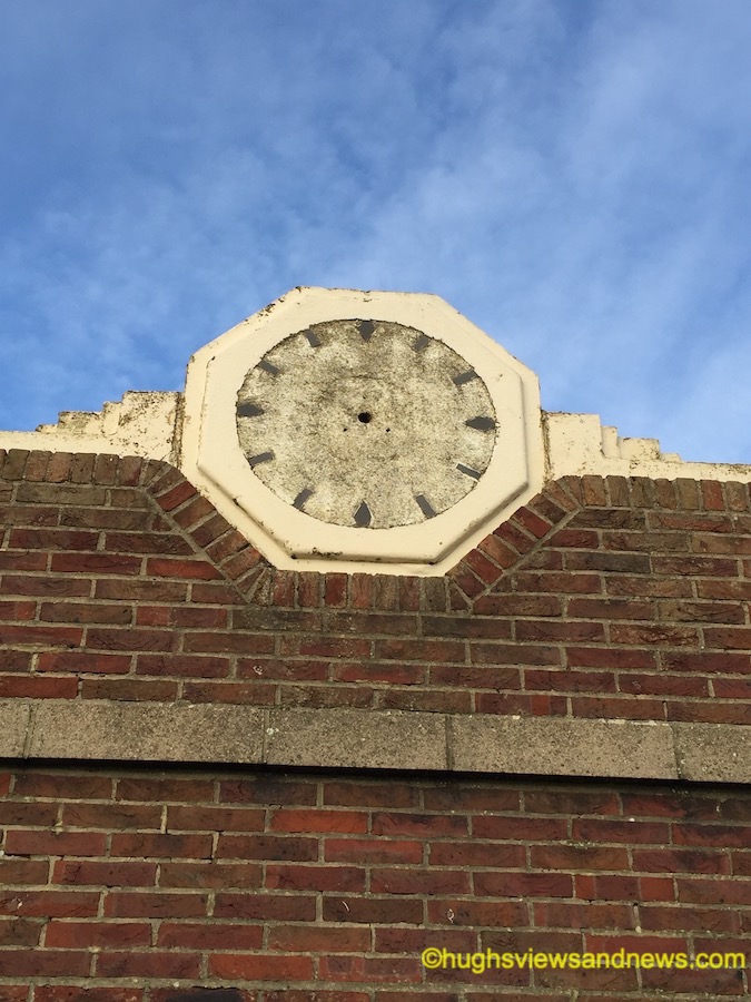 Photo of an old broken clock on a building