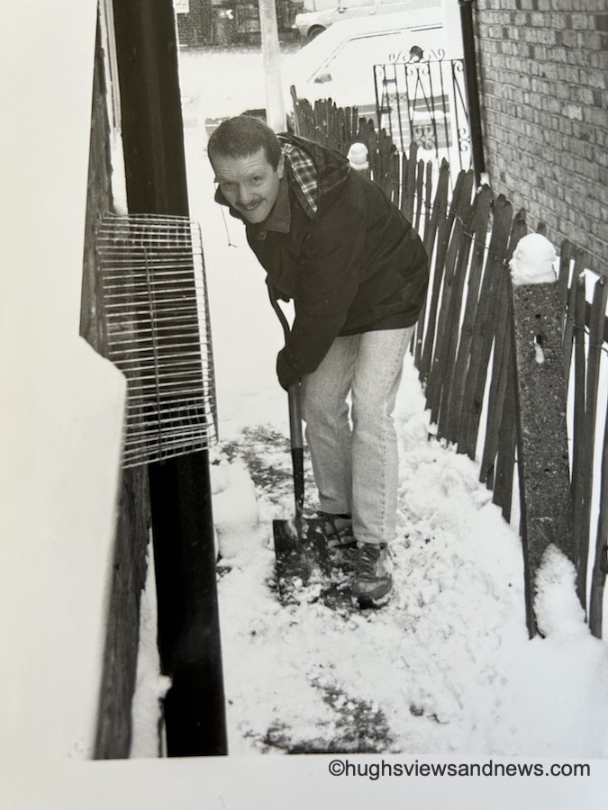 Photo of a young man shovelling snow off a path