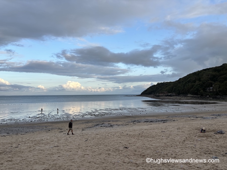Photo of a beach and the sea, with just a few people left on it at the end of the summer season in the UK.