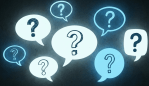 Multiple glowing speech bubbles containing question marks against a dark background.